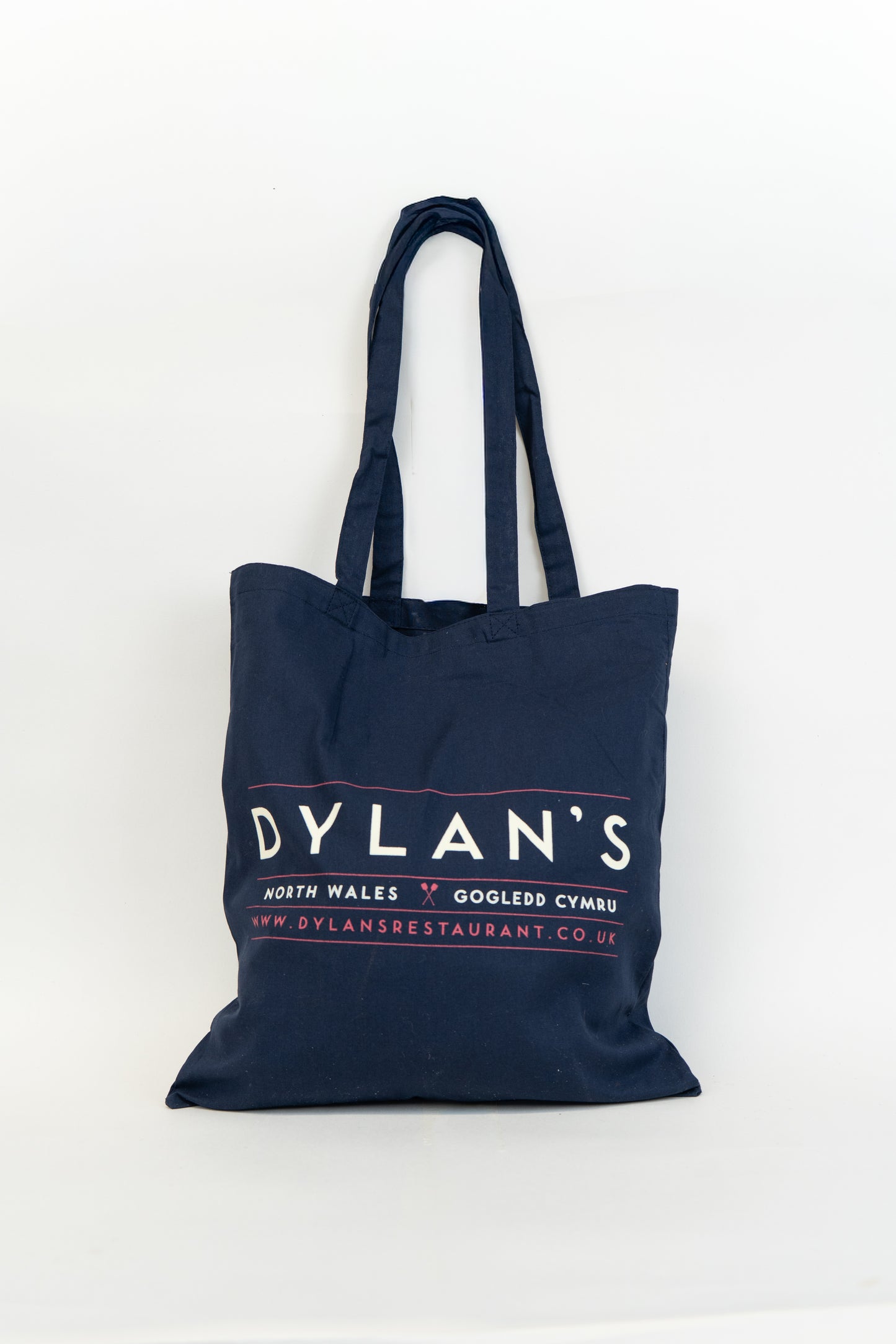 Navy blue tote bag with 'Dylan's' branding on a white background